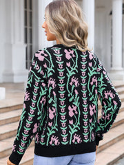 Black crewneck sweater with pink and green floral tapestry pattern, acrylic knit.