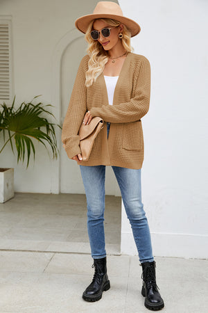 Caramel waffle knit raglan pocket cardigan with open front and long sleeves.