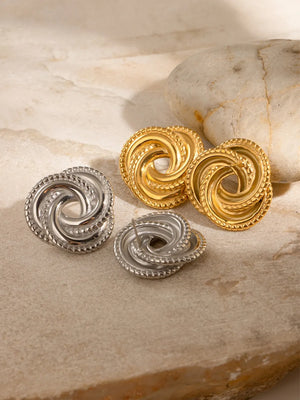 Golden and silver swirl knot stud earrings with textured edges.