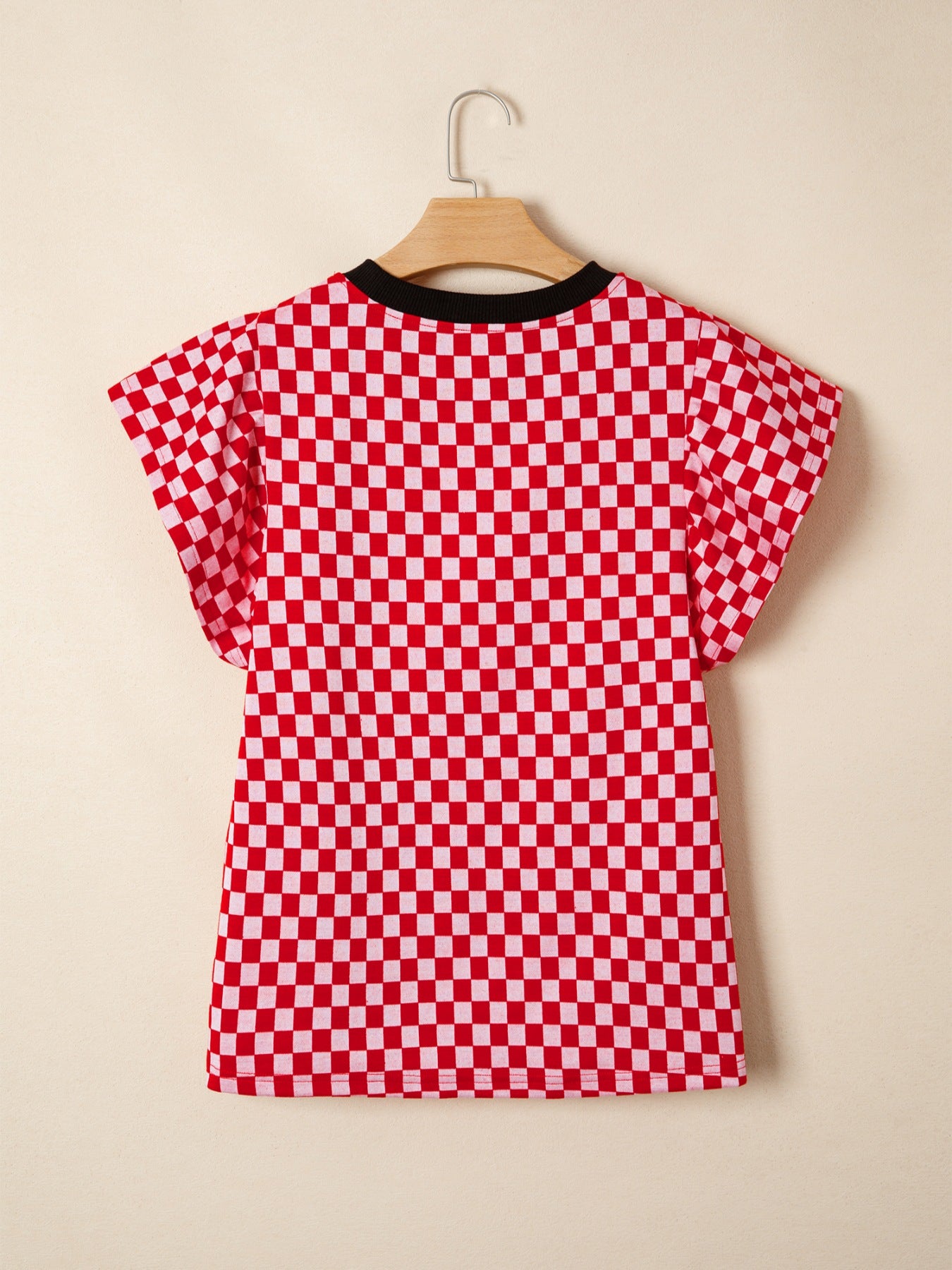 Red and white checkered print shirt with ruffle sleeves and black trim neckline.