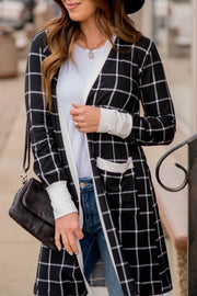 Black and white plaid duster cardigan with white trim and pockets, styled open over a white top.