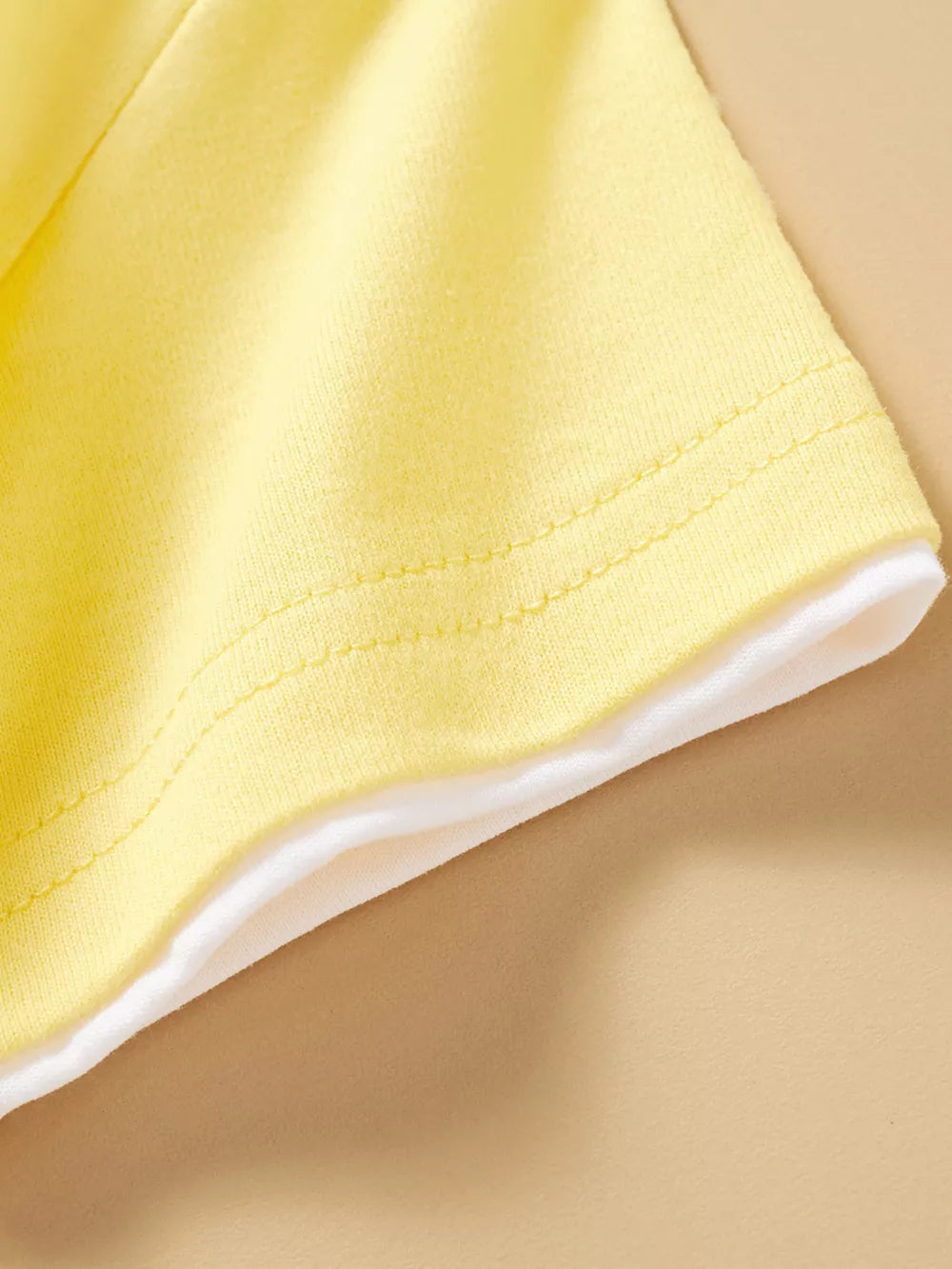 Yellow cotton t-shirt with white trim detail.