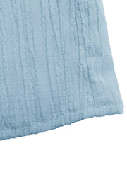 Blue smocked tiered maxi skirt with a textured fabric detail.