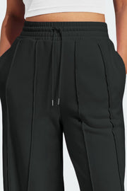 Black seamed wide leg lounge trousers with drawstring waist and pockets.