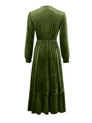 Dark green velvet maxi dress with voluminous sleeves, elastic waist, and ruffled hem.
