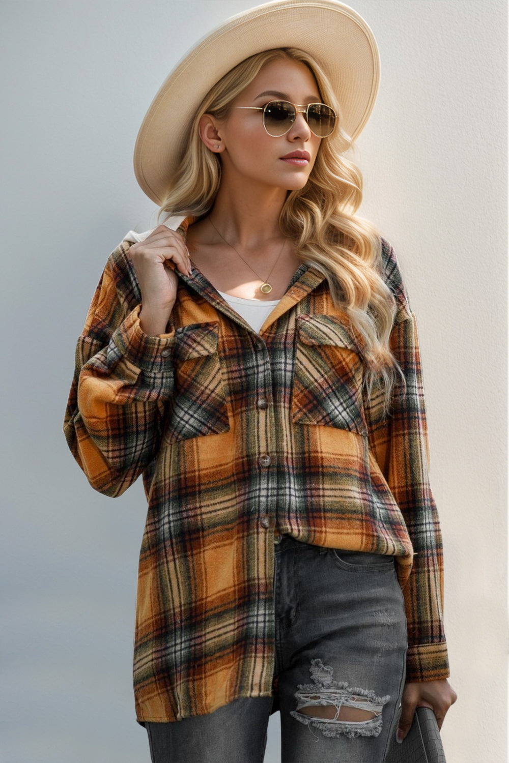 Oversized hooded shirt jacket in sherbet plaid with buttoned front and chest pockets.