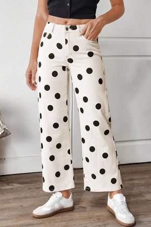 Cream polka dot high-rise jeans with a wide leg and ankle length.
