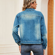 Faded wash denim trucker jacket with a classic collar and button cuffs.