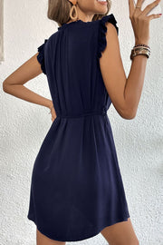 Dark blue ruffled yoke mini dress with tie waist and short sleeves.