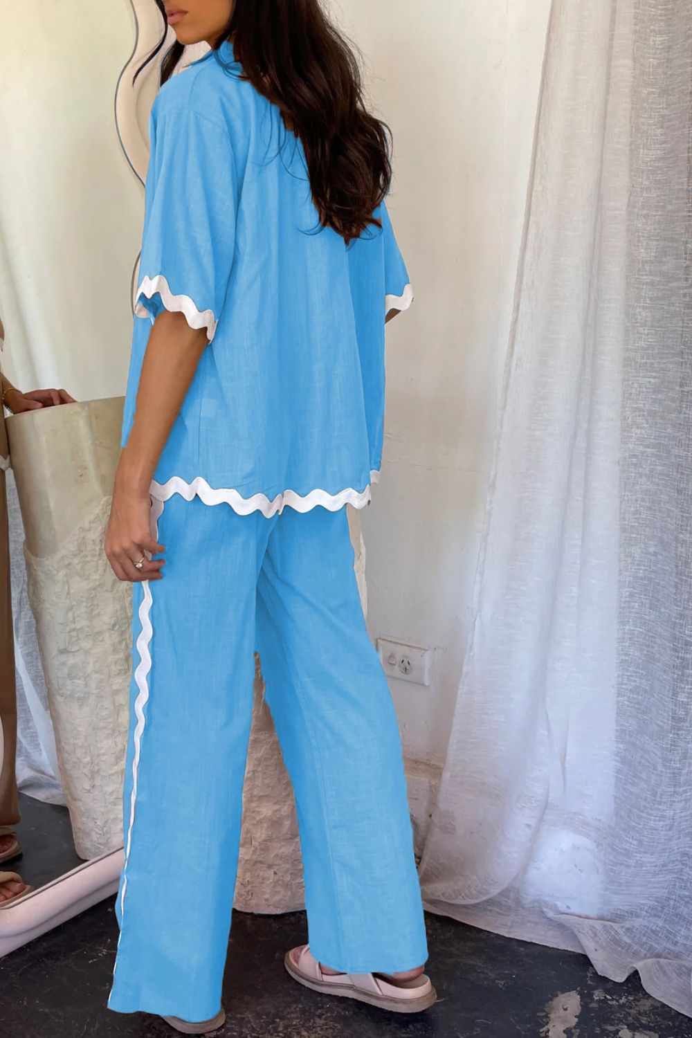 Sky blue co-ord set with scalloped trim on short sleeves, hem, and pant side seam.