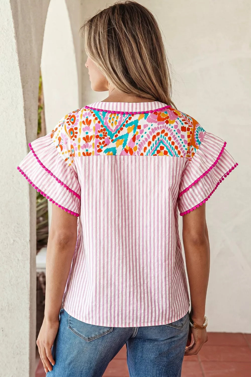 Pink striped blouse with vibrant patchwork yoke and ruffled sleeves.