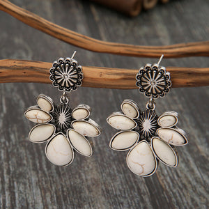 White floral drop earrings with alloy petals and stone accents.