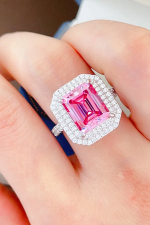 Hot pink emerald cut halo ring with pave diamond band.