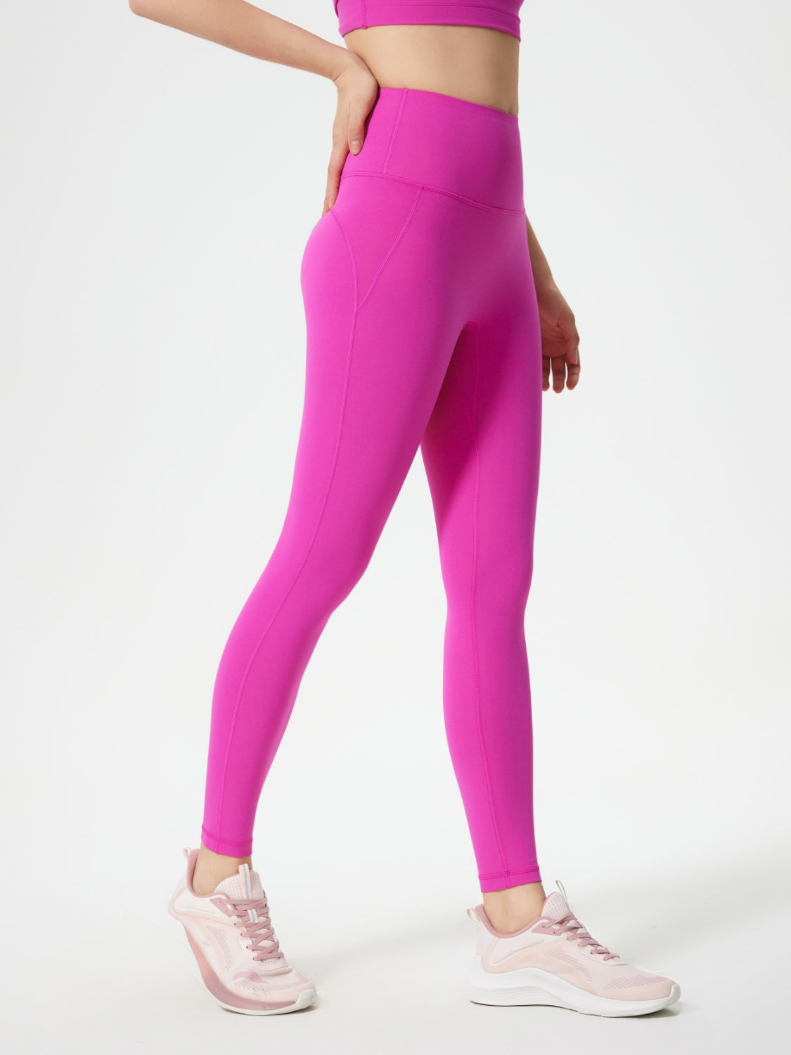 Fuchsia pink sculpted contour leggings with pocket detail and seamless stitching.