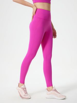 Fuchsia pink sculpted contour leggings with pocket detail and seamless stitching.