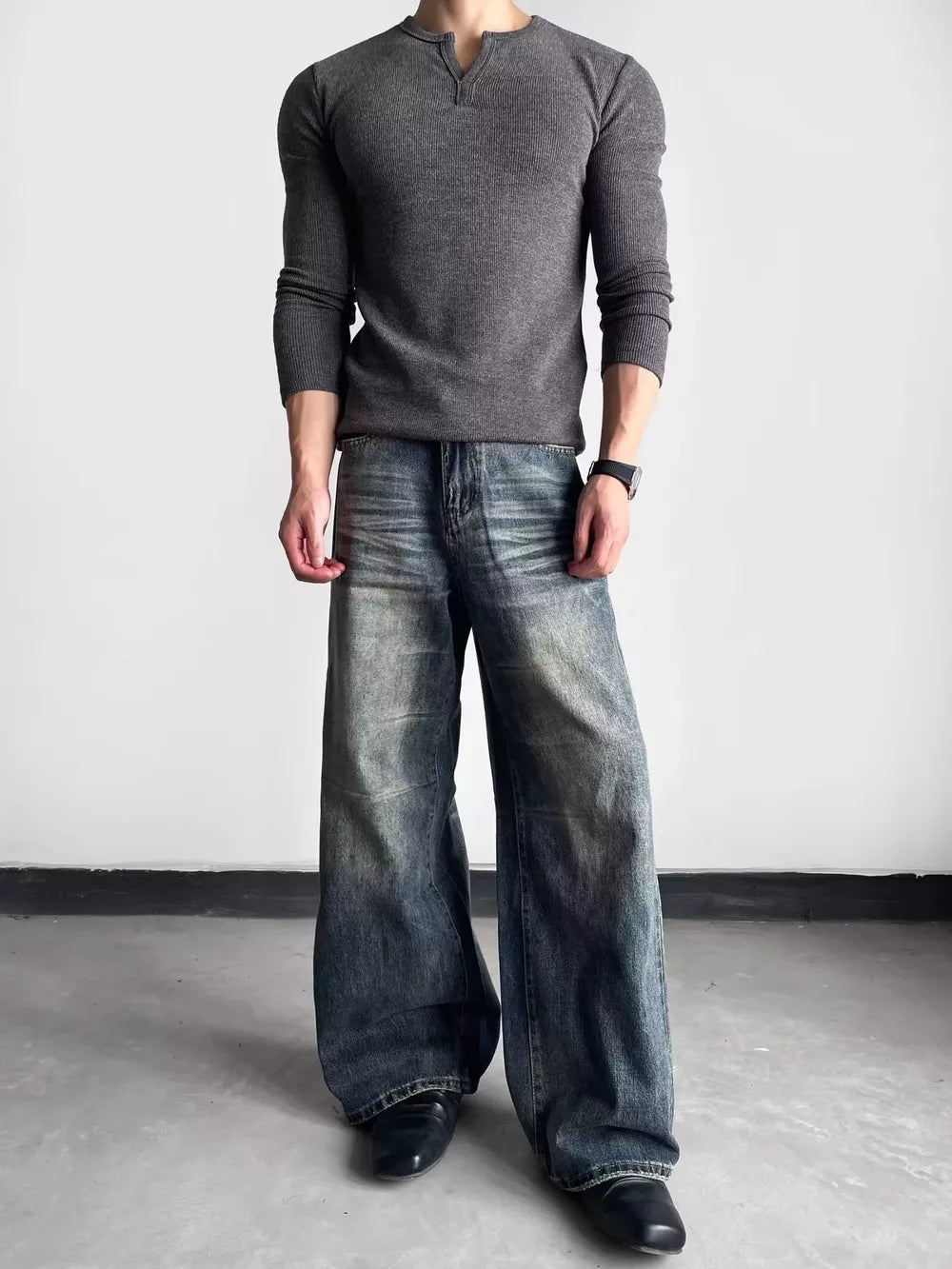 Luxe wide-leg distressed denim jeans in blue, featuring a relaxed fit and vintage wash.