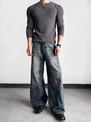Luxe wide-leg distressed denim jeans in blue, featuring a relaxed fit and vintage wash.