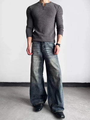 Luxe wide-leg distressed denim jeans in blue, featuring a relaxed fit and vintage wash.