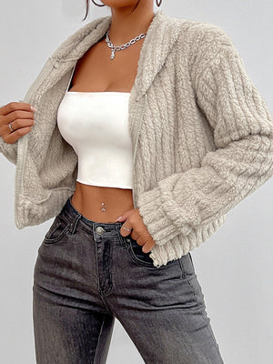Beige textured cropped teddy zip-up hoodie with a fuzzy finish and ribbed cuffs.