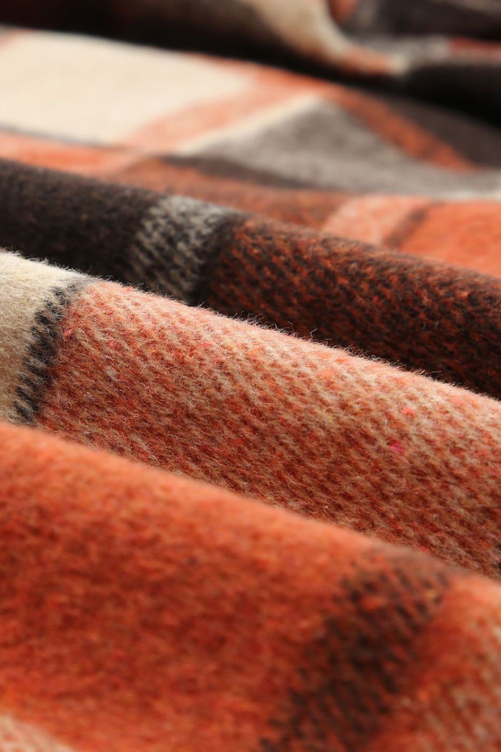 Plaid hooded shacket in orange and tan wool blend fabric with a soft texture.