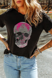 Black t-shirt with a pixelated pink and gray skull graphic, crew neck, short sleeves.