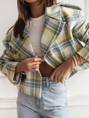 Boxy plaid cropped blazer in cream with green, yellow, and blue plaid.