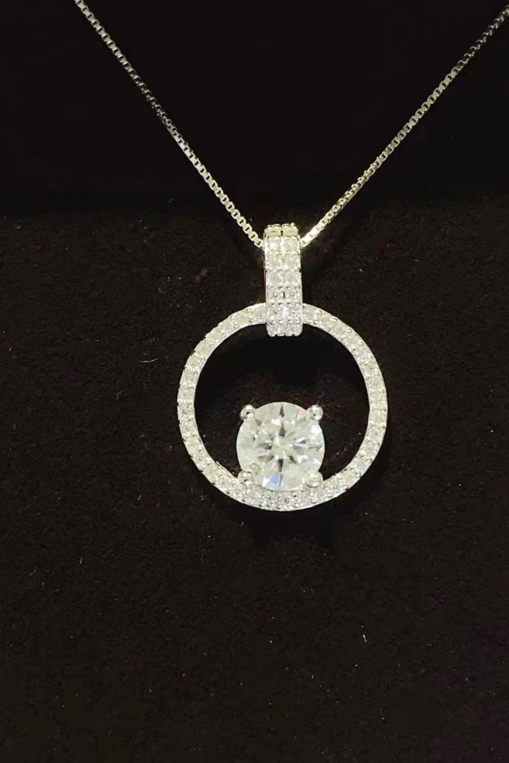 Silver halo moissanite circle pendant necklace in 925 sterling silver with pavé details.