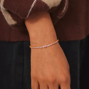 Gold tennis bracelet with pink heart zirconia charm and pink stones