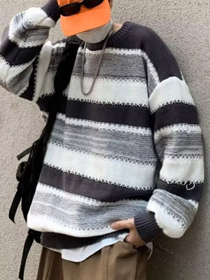 Relaxed fit gray and white striped sweater with white decorative stitching detail.