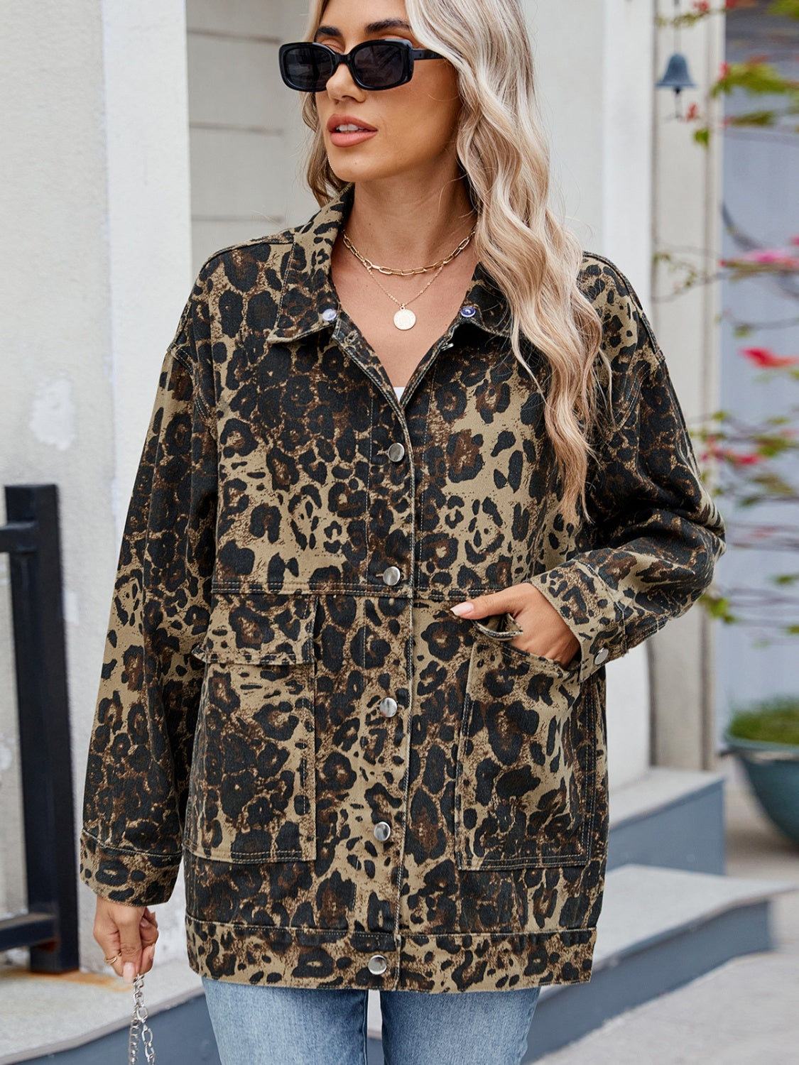 Leopard print denim utility jacket with button front and chest pockets.
