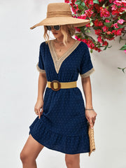 Dark blue Swiss dot dress with crochet trim and ruffled hem.