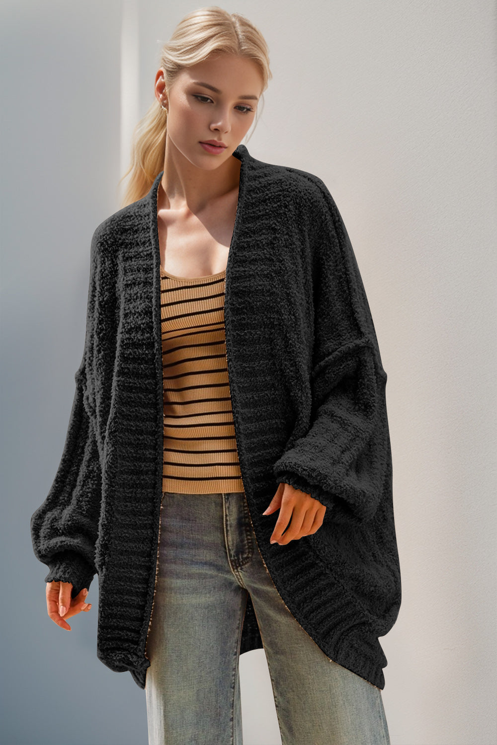 Black textured bouclé cocoon cardigan with balloon sleeves and open front.