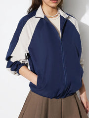 Colorblock raglan sleeve bomber jacket in dark blue and light grey with elastic cuffs and hem.
