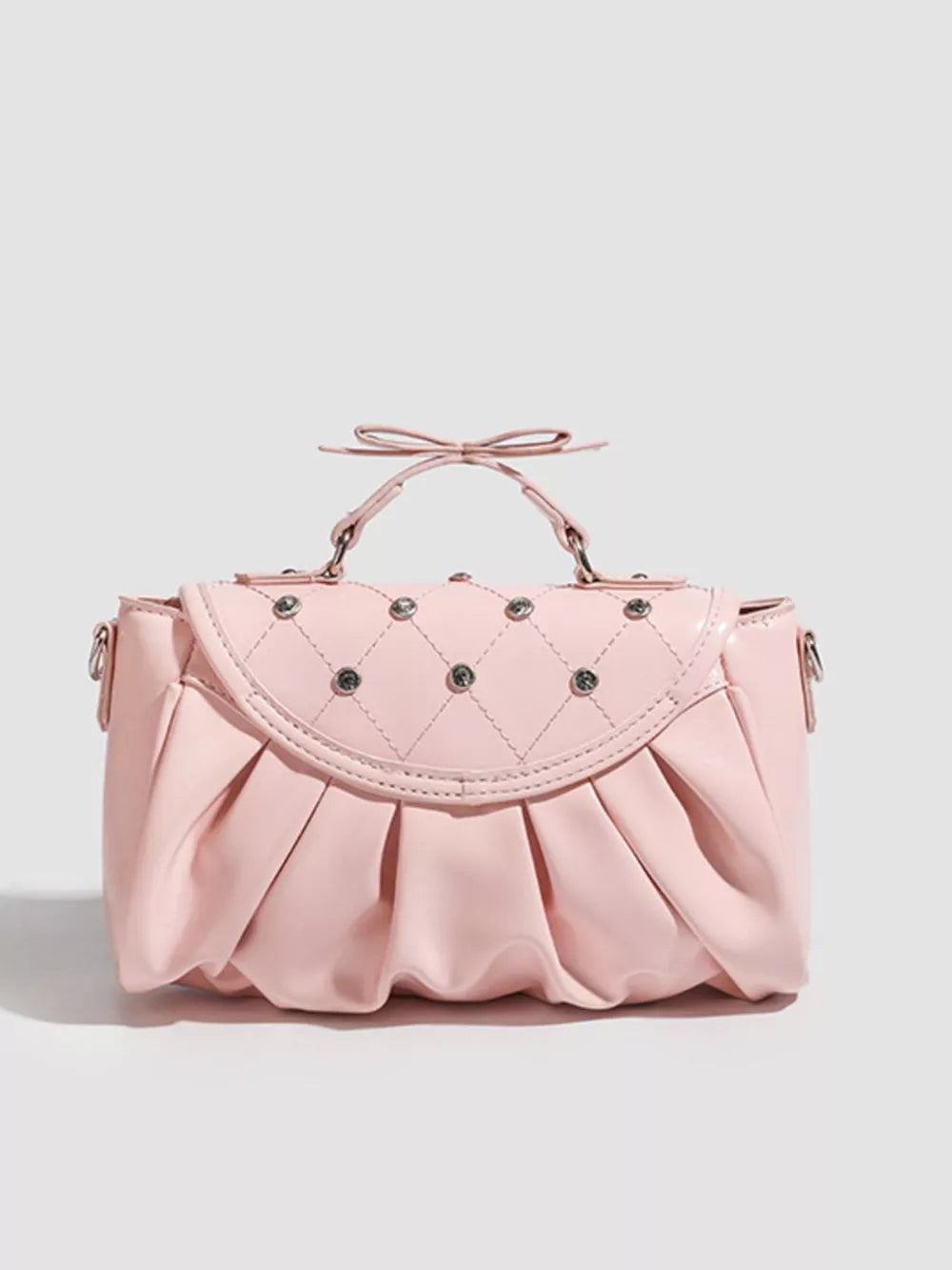 Pink ruched crossbody bag with diamond quilting and bow detail