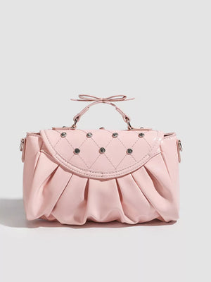 Pink ruched crossbody bag with diamond quilting and bow detail