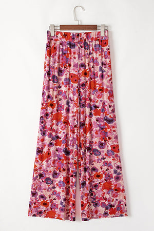 Painterly floral palazzo trousers in strawberry with a wide leg and elastic waistband.