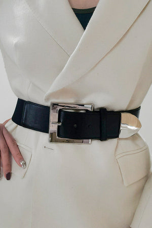 Black faux leather belt with a bold silver sculpted buckle and tip.