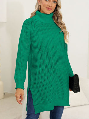Dark green knit turtleneck sweater with asymmetric hemline and side slits.