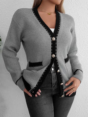 Gray knit cardigan with black contrast trim and gold buttons, featuring patch pockets.