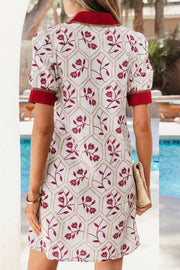 Floral print short sleeve dress with red trim and pockets, cotton blend.