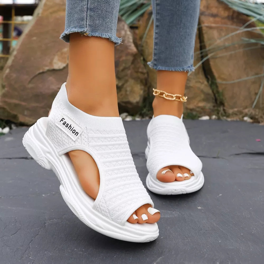 White sporty chunky platform sandals with breathable knit upper and "Fashion" tag.