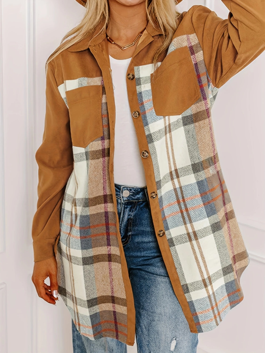 Caramel shacket with plaid panels and contrast sleeves, featuring button front and chest pockets.