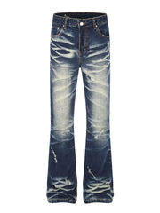 Distressed flare jeans in dark wash blue cotton with pocket details and button fly.