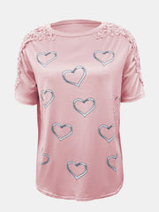 Blush pink tee with heart print and lace trim on shoulders and sleeves.