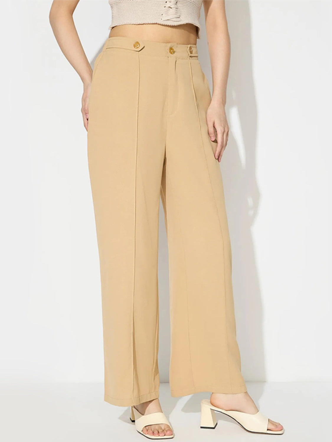 Tan tailored seam front wide leg trousers with button detail.
