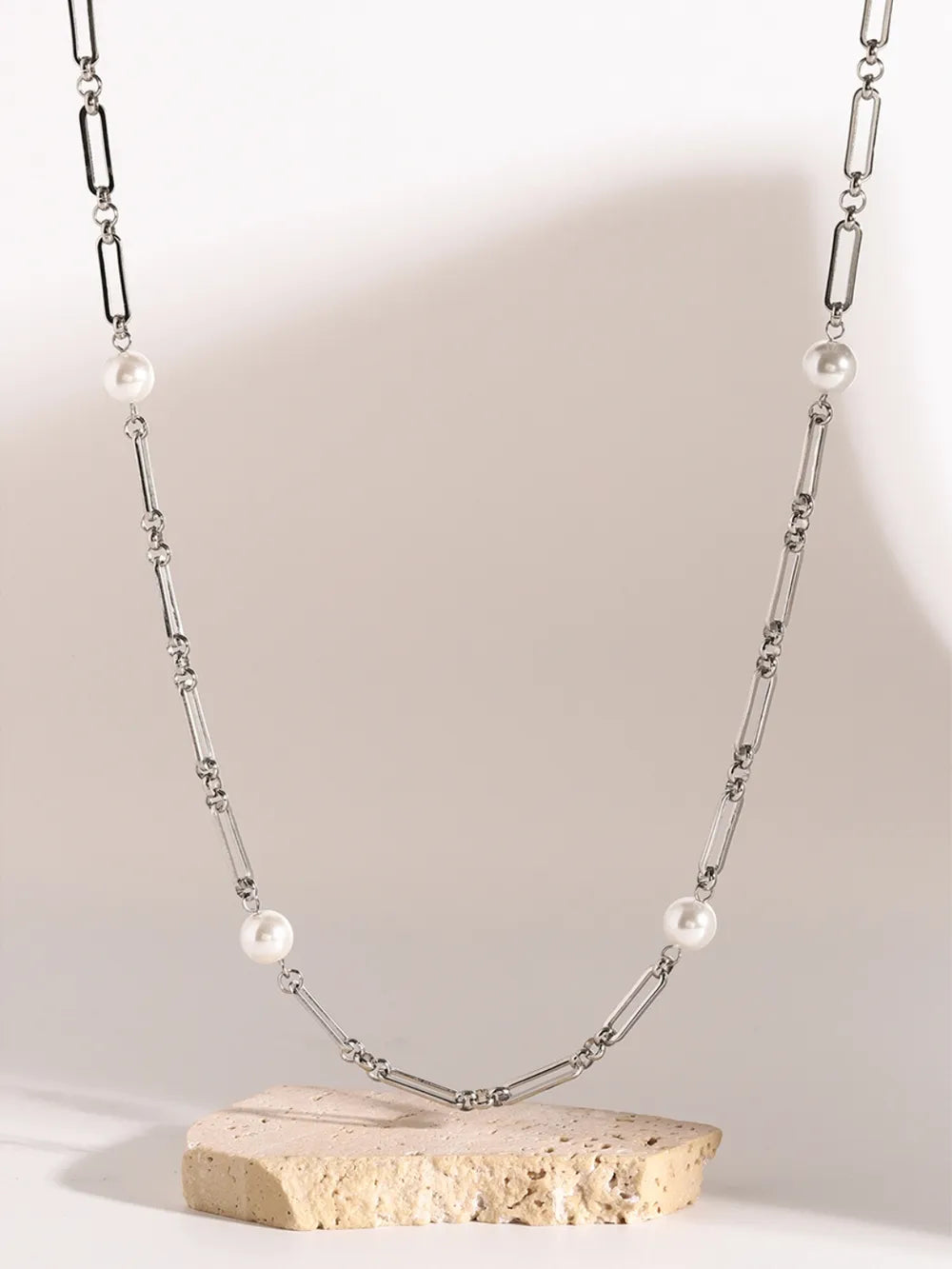 Silver two-tone pearl link necklace with oval and bar chain links.