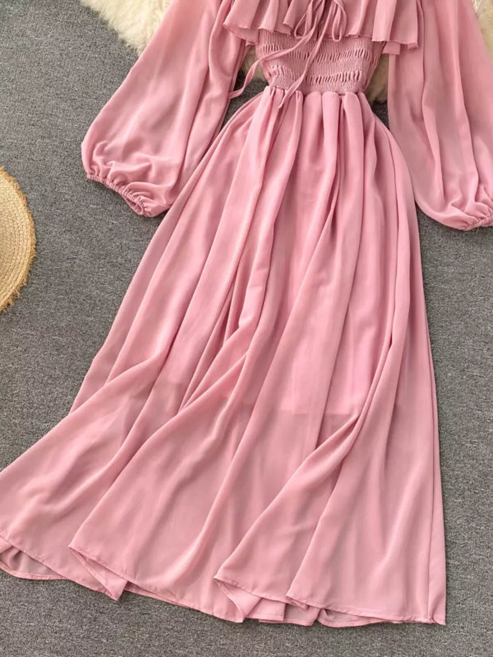Pink maternity dress with ruffled square neck, smocked bodice, balloon sleeves, and A-line skirt.
