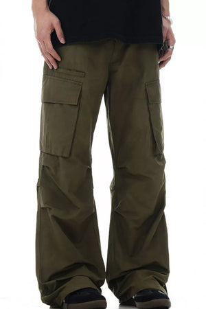 Olive green relaxed fit cargo pants with multiple pockets and a casual style.