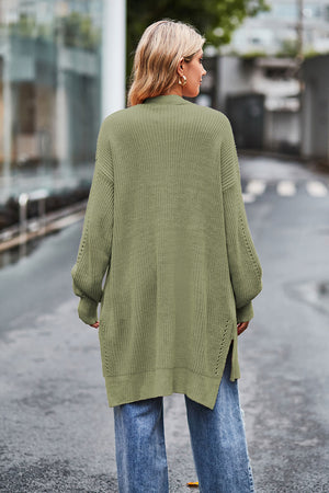 Sage open-knit longline cardigan with side slits and textured sleeves.