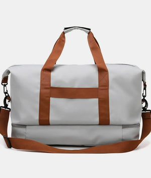 Gray dual-compartment weekender bag with contrast brown straps and shoulder strap.